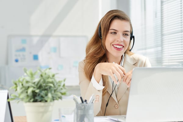 Woman on phone with headset - business phone services